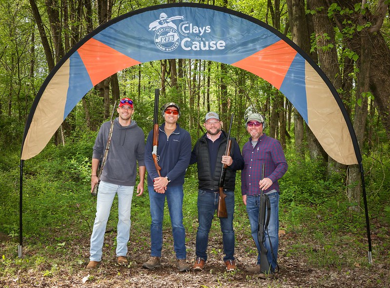 Four men under Clays for a Cause banner
