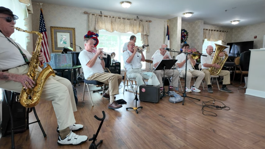 Britton Fugazzi plays trombone with other musicians